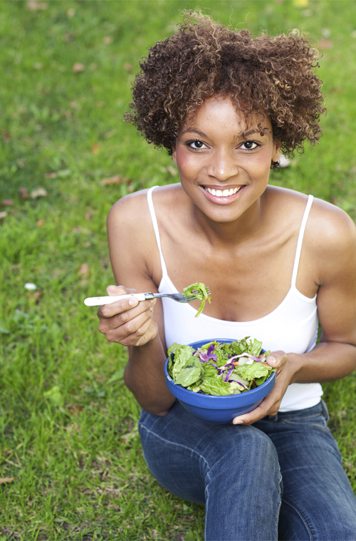 Woman enjoying one of our healthy summer salad recipes