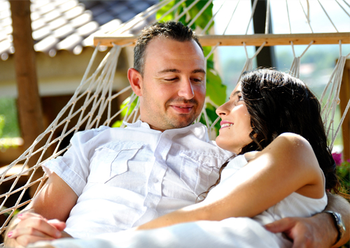 An attractive couple in a hammock dating after weight loss