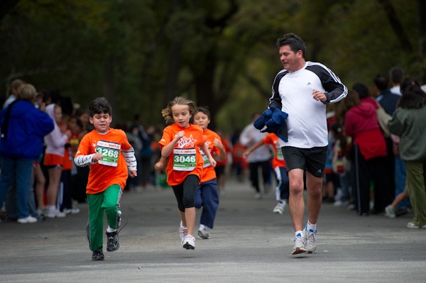 Family running together at the YMCA reducing obesity