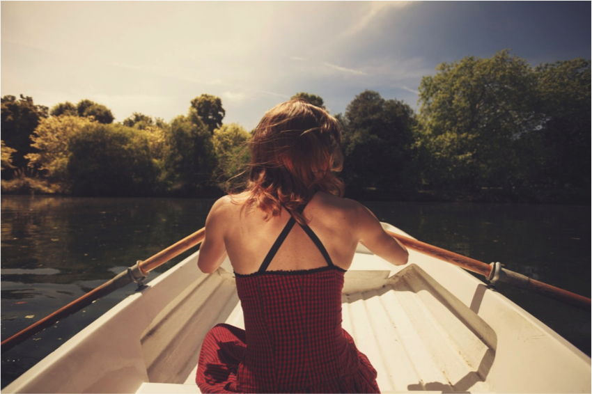 Young woman boating on a lake