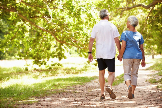 Senior couple walking in woods