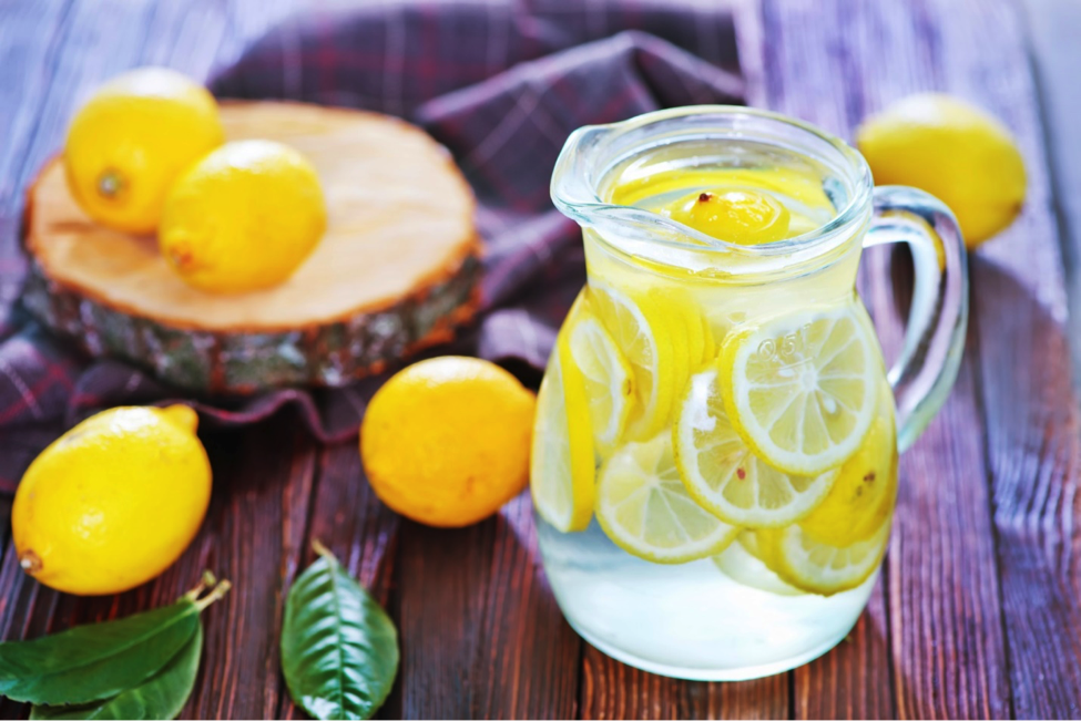 A pitcher of homemade lemonade on a table.