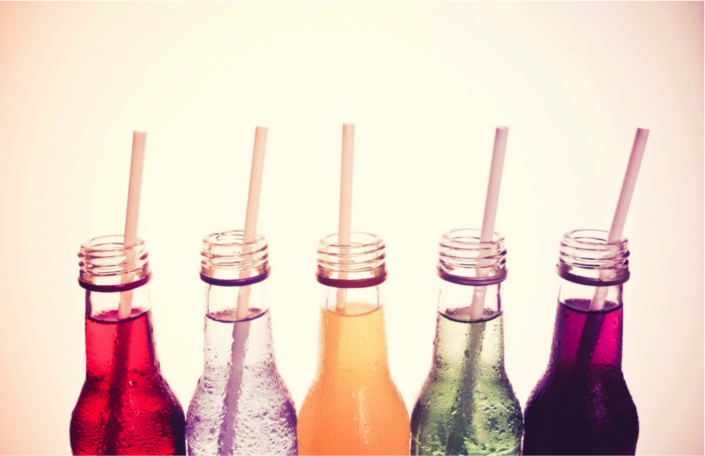 Four glass bottles of various colors