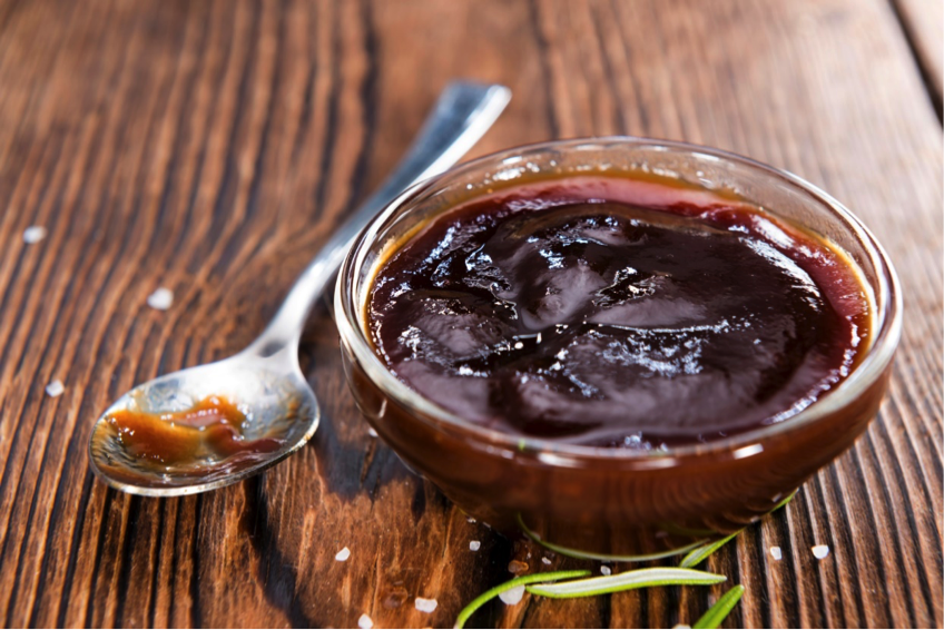 Healthy BBQ sauce in jar next to brush.