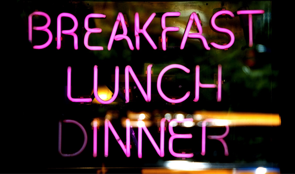 Sign lit up to show the words: breakfast, lunch, dinner.
