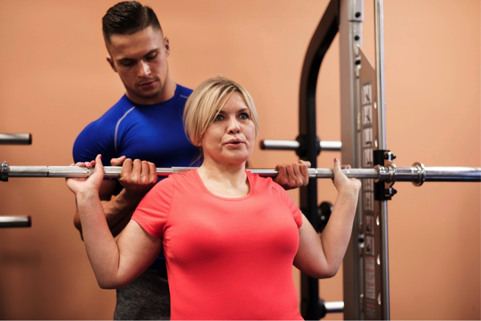 Overweight woman working out with personal trainer as her fitness technique