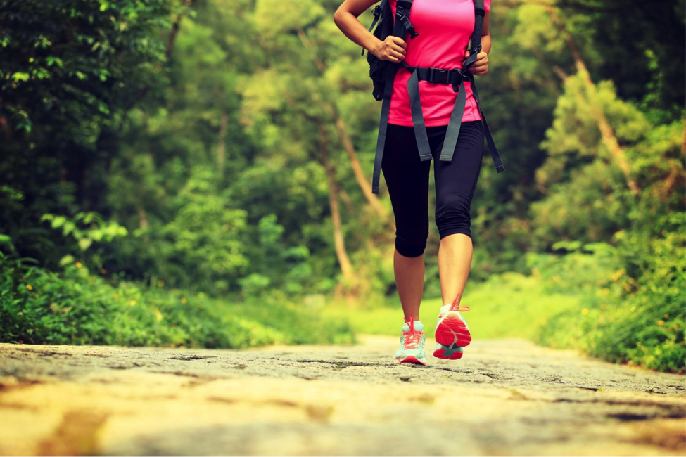 Person hiking along trail as an outdoor fitness idea.