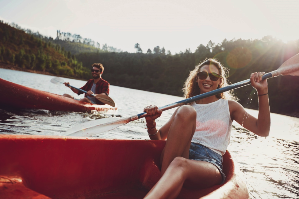 Woman and many kayaking next to each other.