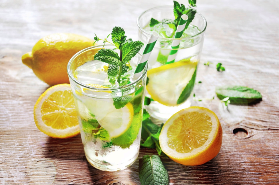 Lemon in water glasses with lemon slices on a table