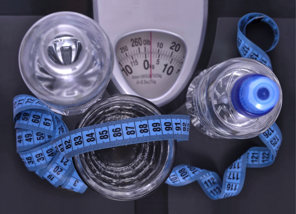 Water bottles, cups, scale, and measuring tape bundled together
