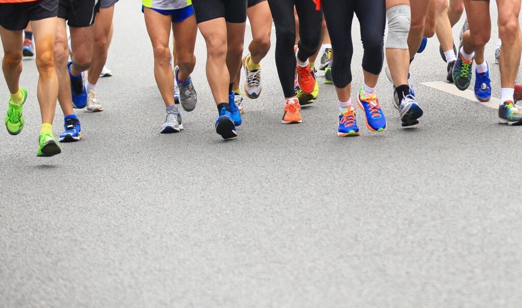 Legs of runners at a San Antonio Thanksgiving marathon event