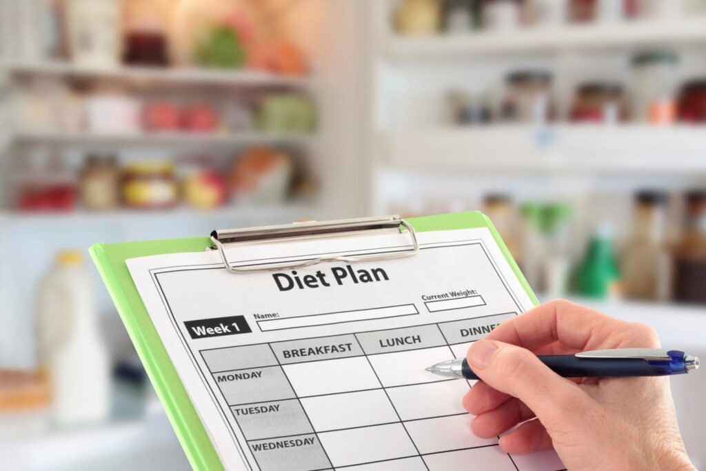 Person going ketogenic writing a diet plan