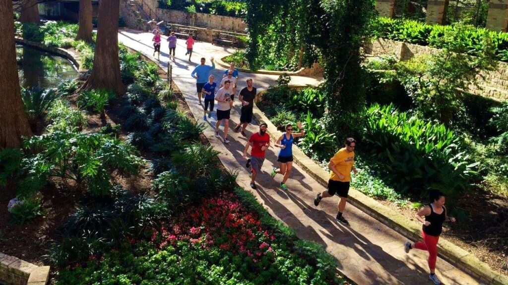 Runners jogging through Riverwalk for a San Antonio post-Thanksgiving event