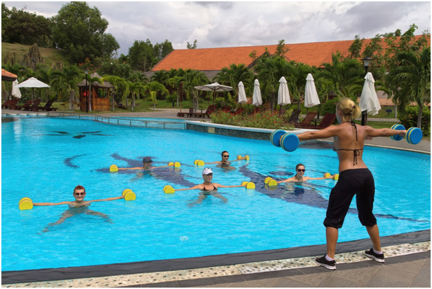 Group of people working out in a pool