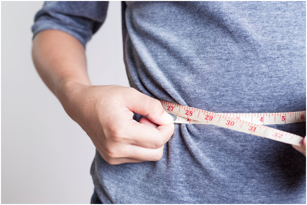 Person measuring weight after Obalon Intragastric balloon procedure