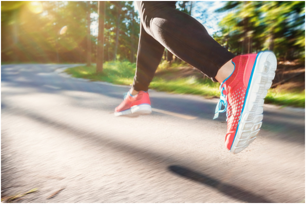 Woman jogging through a park