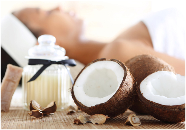 Woman relaxing at spa with open coconut