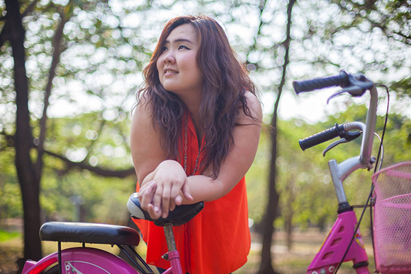 Woman with healthy body image enjoying the outdoors with her bike