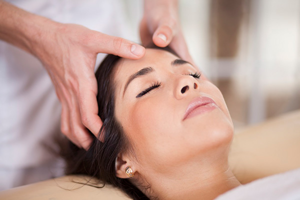 A woman enjoying a head massage