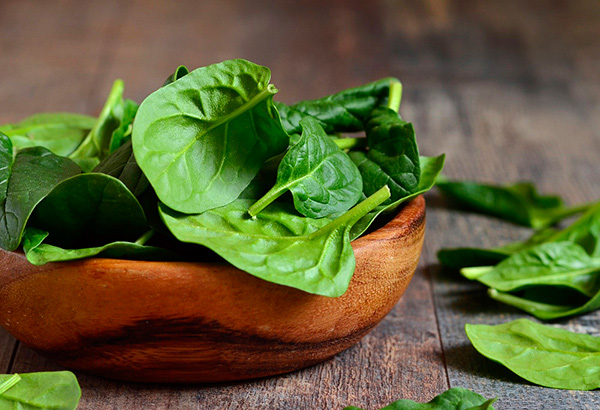 Brown bowl of organic spinach