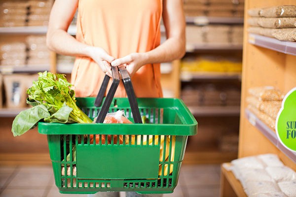 Woman carrying basket of food items to prepare for a healthy Lent.