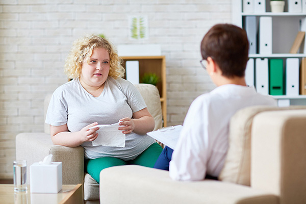 Plus-size woman getting therapy from another woman for a healthy Lent.