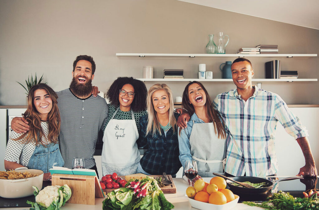 Group of young adults taking a cooking class to check off part of their healthy spring bucket list.