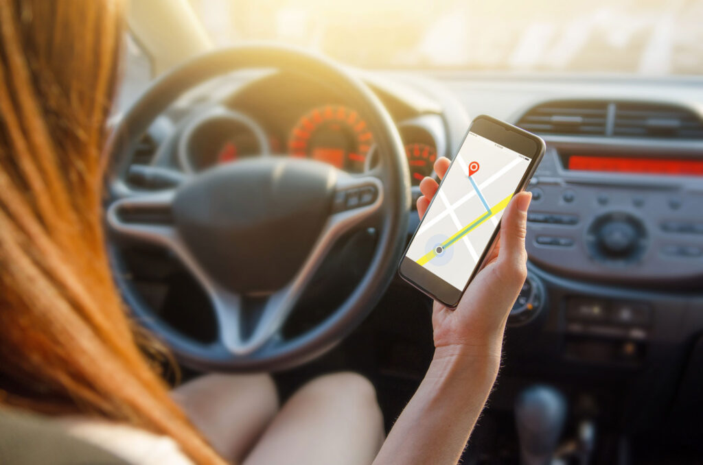 Close up of woman using iPhone maps as she learns how to eat healthy while traveling.