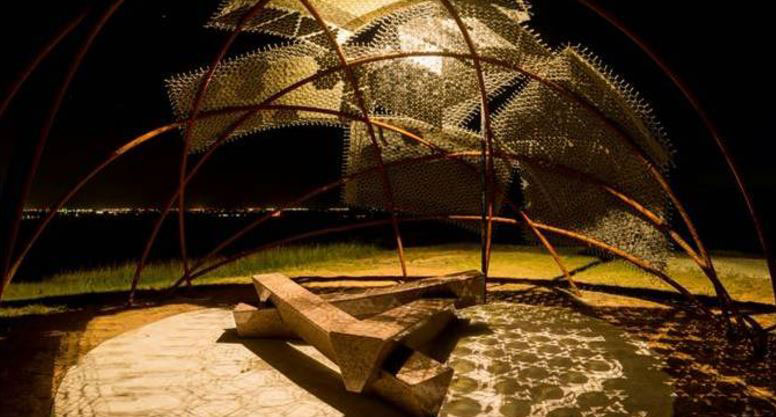 Night view of a lit up modern and artistic structure at one of the best San Antonio parks, Pearsall Park.