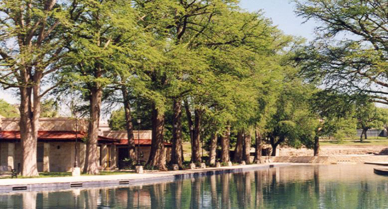 View of water and trees at one of the best San Antonio parks, San Pedro Springs Park.
